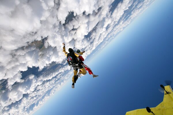 Fallschirmspringer schweben in der Luft über den Wolken