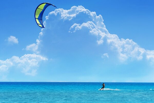 Surfing in the blue ocean against the blue sky