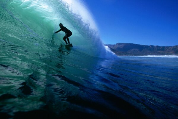 A man on a board rides on the waves