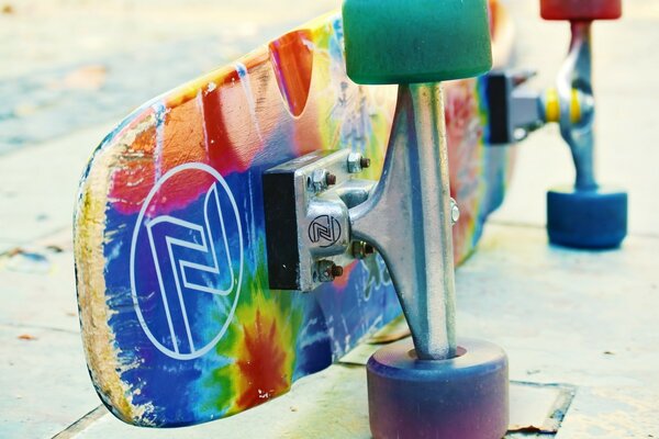 A multicolored skate is lying on its side