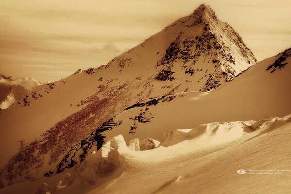 Snowy mountain peaks in sepia color