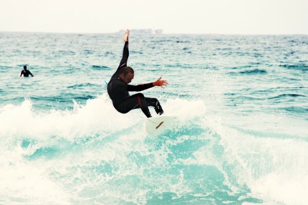 Bold surfing on the sea wave