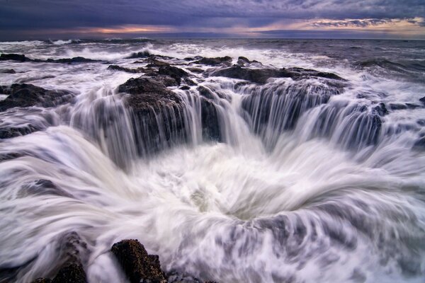 A waterfall that turns into a funnel in the ocean