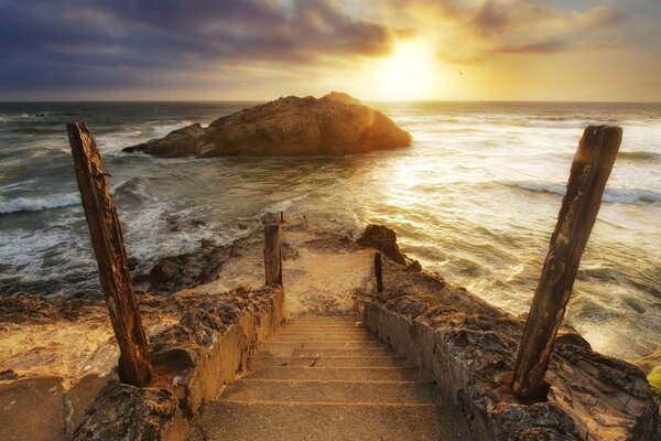 Country descent down the stairs to the sea during sunset