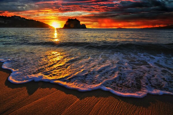 Beautiful sunrise on the beach by the water