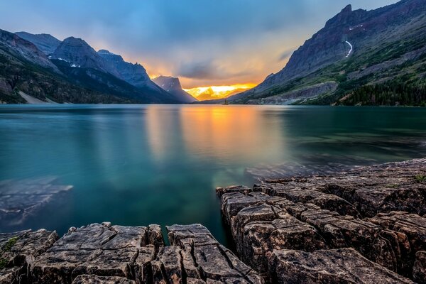 L eau magnifique près des rochers au milieu des montagnes