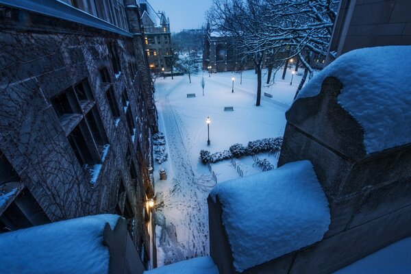 A snow-covered courtyard with lanterns, a winter night in America