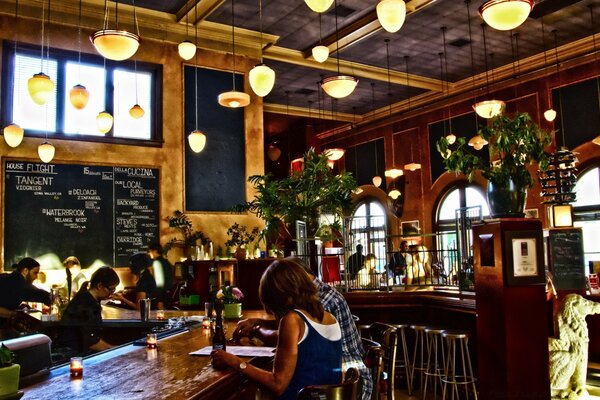 Dans le bar assis une fille et un gars, ils regardent le menu