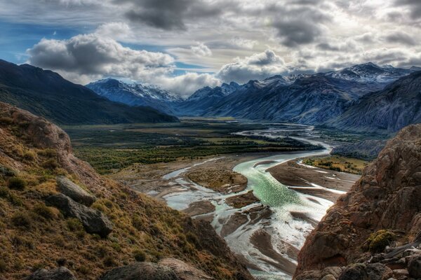 Cloudy sky over a mountain river