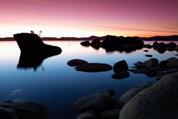 Sunset in America on the background of water and rocks