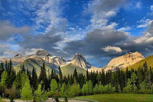 Landscape with mountains forest and clouds