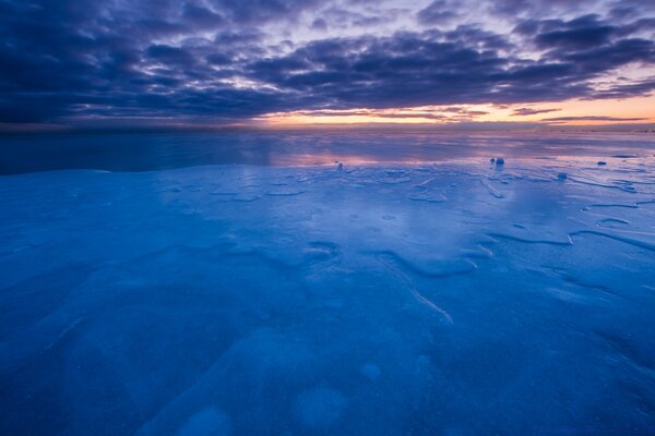 Part of the sea froze under the dark sky