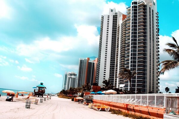 Sandy beach on the background of high-rise buildings