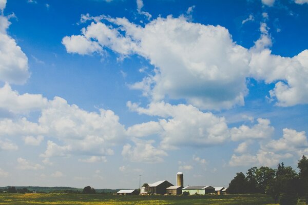 A lot of clouds, a village in the distance