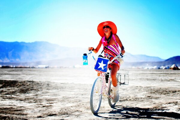 A girl with bags rides a bicycle