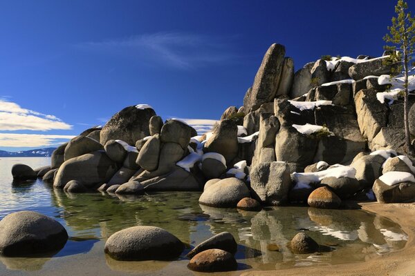 Photo of rocks made of stones on the lake shore