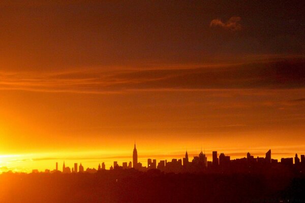 The dark silhouette of the city at sunset