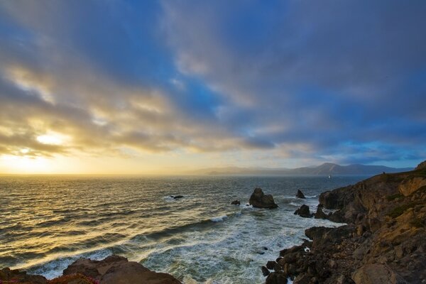 Waves beat against the rocky shore