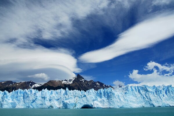 Blue glacier on a blue sky background