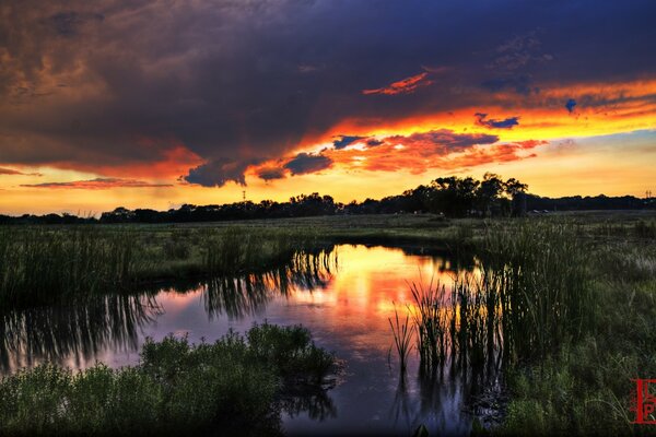 Der Sonnenuntergang spiegelt sich im Fluss wider