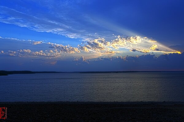 Lake on the background of snow-white clouds