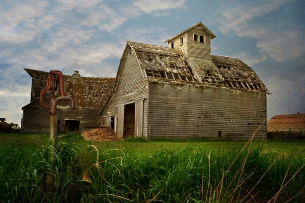 An old abandoned house on a green lawn