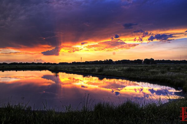 The sun rises over the black lake