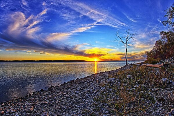 Sunset of the landscape sun by the water