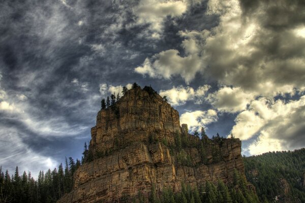 A big rock with a gloomy sky