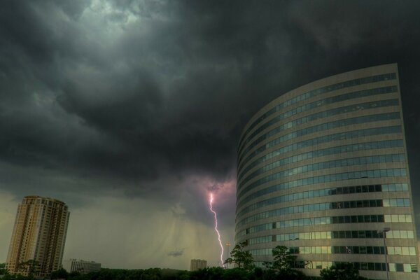 A building with mirrored windows at the moment of heavenly lightning