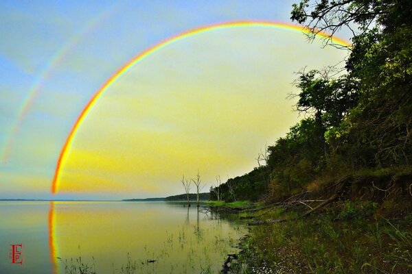 Rainbow landscape. Reflection in water