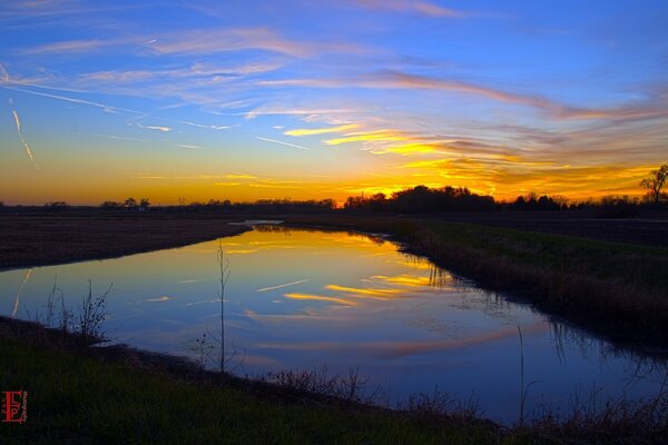 The lake in the beautiful sunset rays