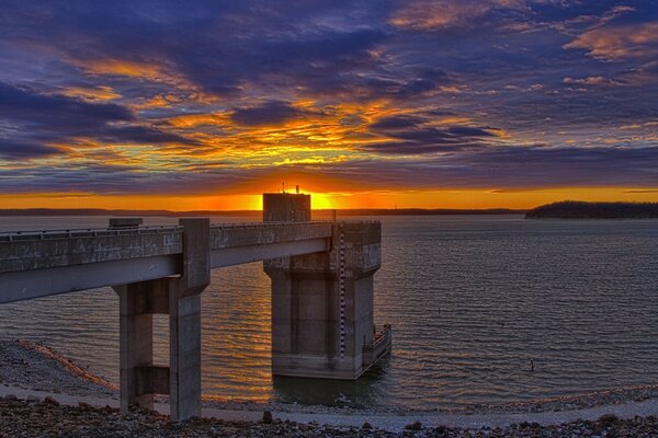 Sunset with clouds in the sky by the water