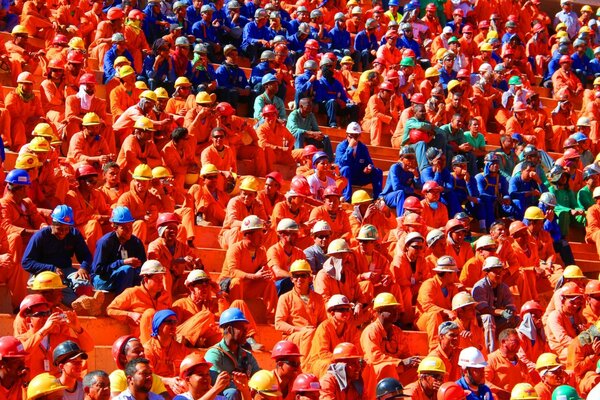 Hard workers in a multicolored uniform are sitting