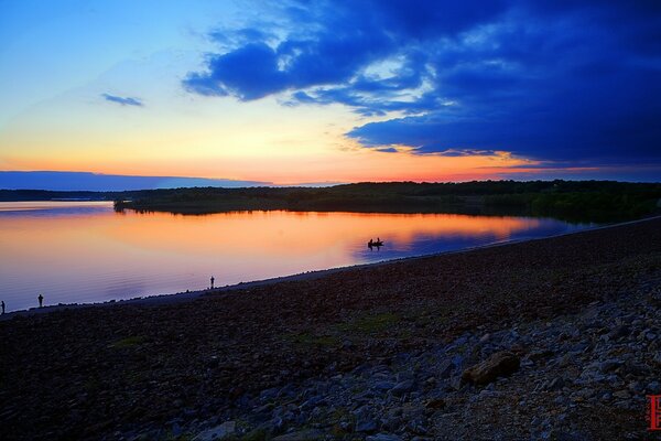 Sunset on the river with views of mountains and clouds