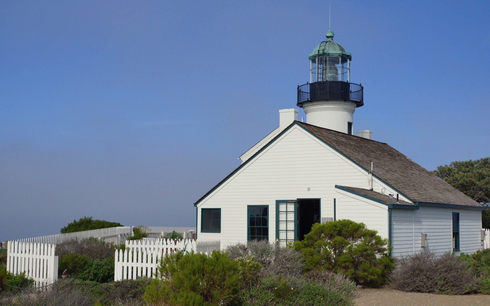 america lighthouse house architecture daylight building outdoors sky seashore tree home travel construction