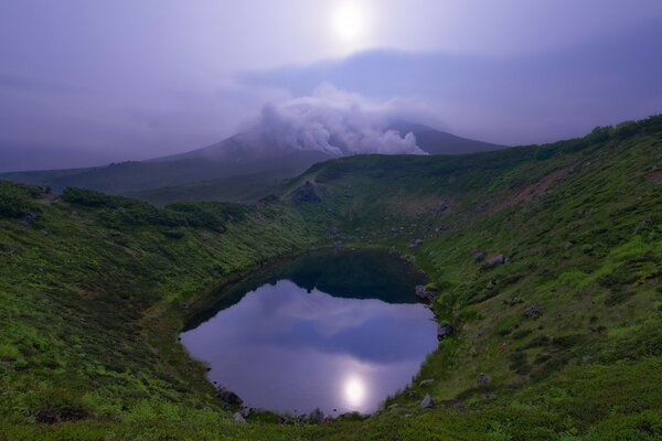 Mountain lake on the background of a foggy sky