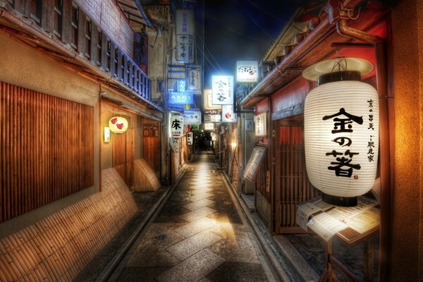 A narrow Asian street with bright signs