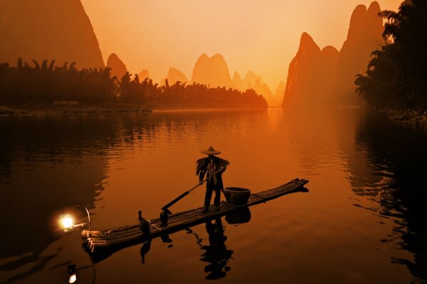 A canoe with a man in the sunset