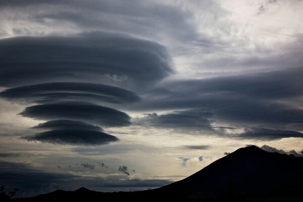 Silhouette of mountains against storm clouds