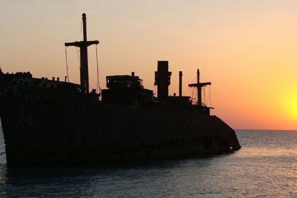 A ship at sunset on the seashore