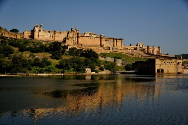 The castle on the shore is reflected in the water