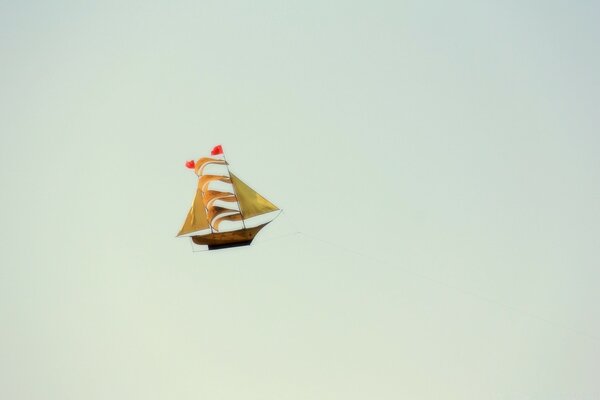 Asian junk boat floats alone on a blue background