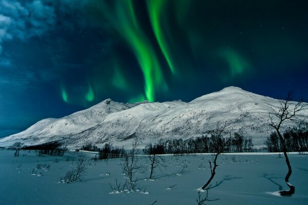 Northern Lights over snow-capped mountains