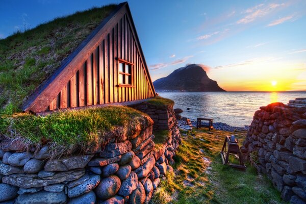 Stone hut on the lake shore