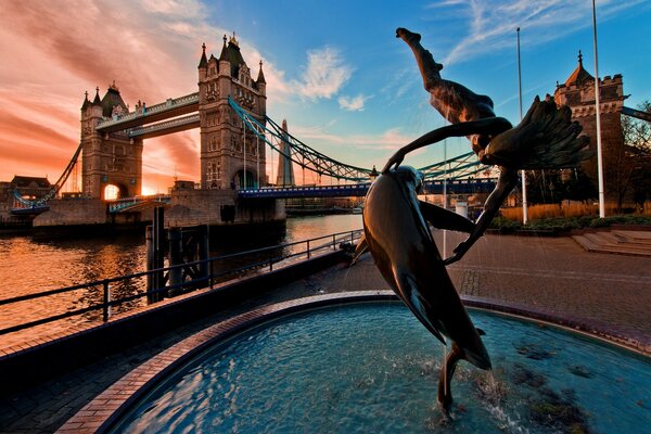 A man with a dolphin. composition on the river bank