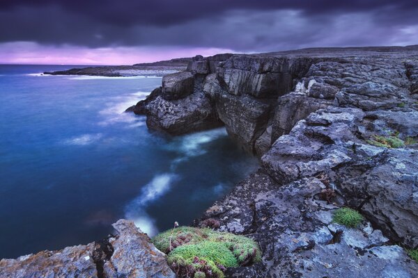 Black sky. Sea and rocks