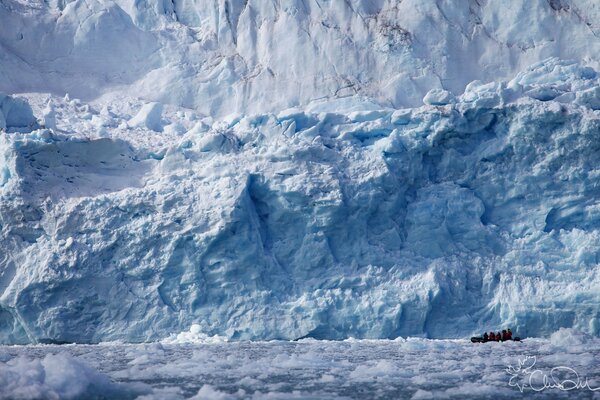 People are looking at a huge glacier