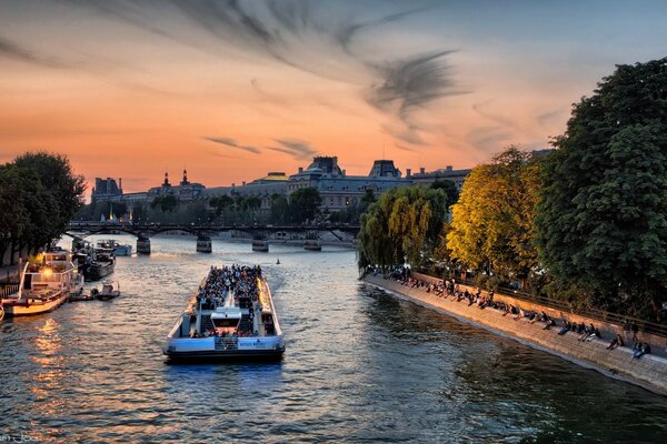 The watercraft travels through the waters of the river