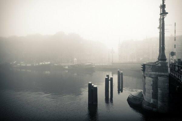 Black and white view from the bridge into the fog